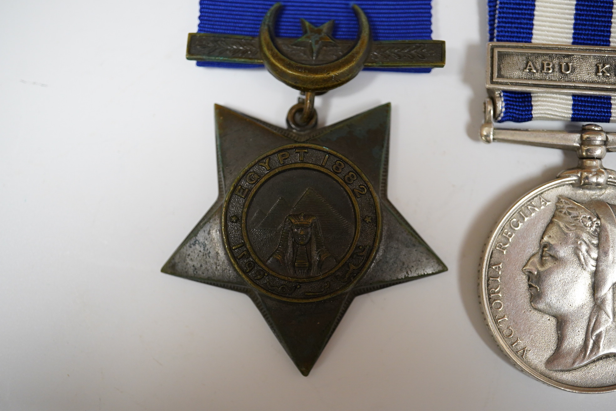 An Egypt Medal 1882-89 with Abu Klea clasp to Corpl H.Bennett 4th Coy. 2nd Batt. Gren. Gds. and a replica Khedive's Star 1882.